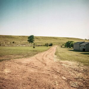 a long dirt road with tire marks