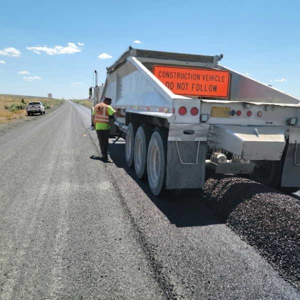 asphalt being poured from a truck