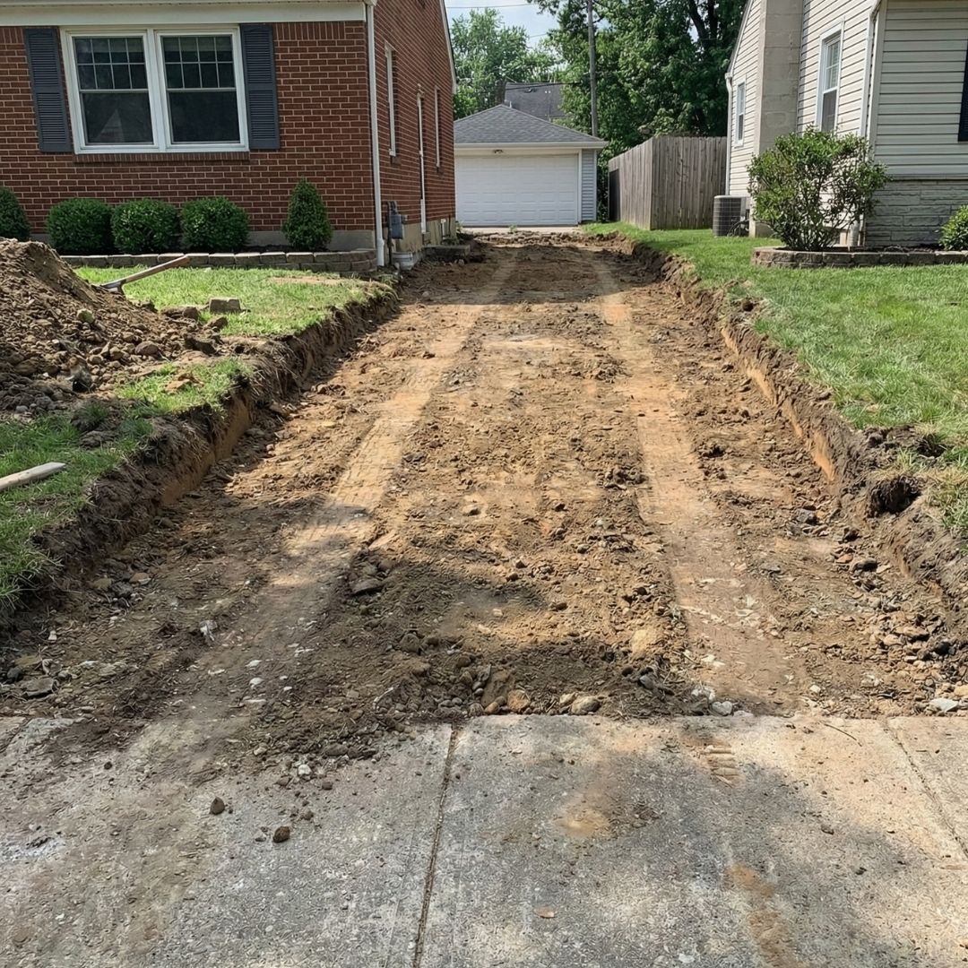 An old driveway is being excavated for a full replacement.